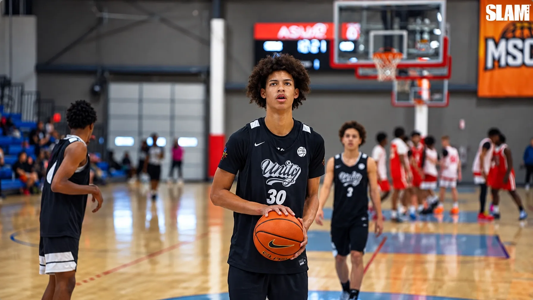 Tresor Childress standing on the court with a basketball in a black Unity number 30 jersey